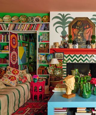 a maximalist living space with full and wall-to-wall bookshelves and a zig-zag fireplace