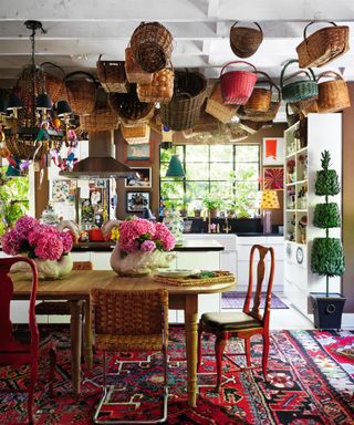 dining room with a basket hanging from the ceiling and a turkish style rug